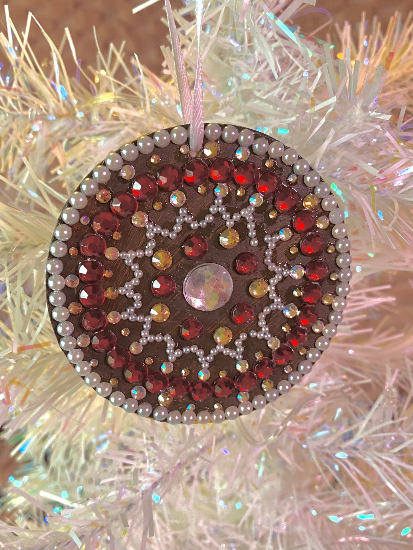 brown round ornament with white and red gems