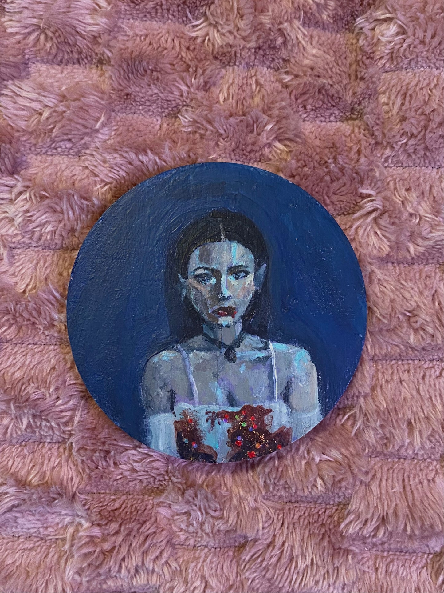 round disk with Megan Fox in a white dress with glittery blood on it