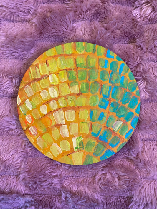 flat round disc with a disco ball painted on it in yellow and green