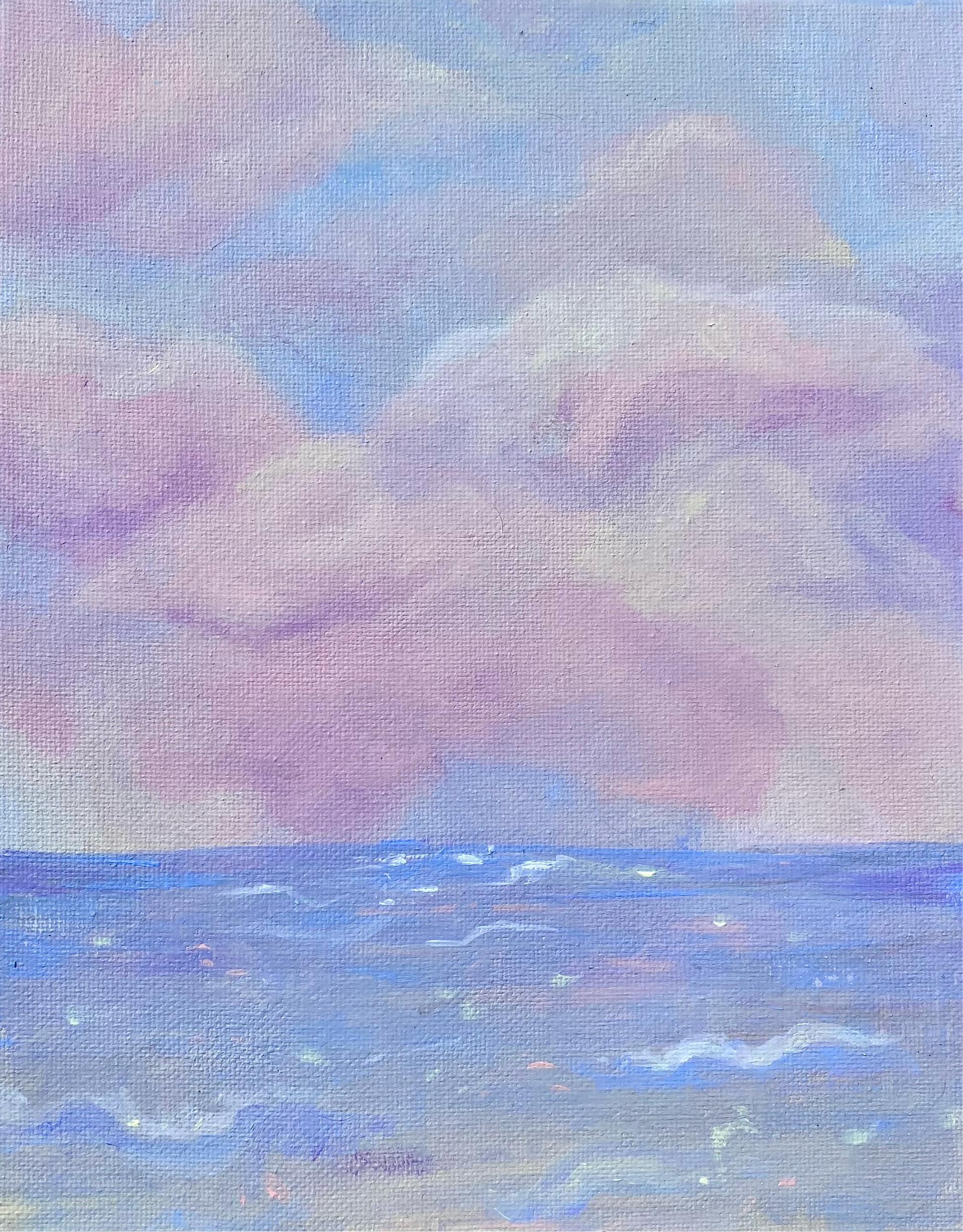 pink and white clouds over a soft blue sea