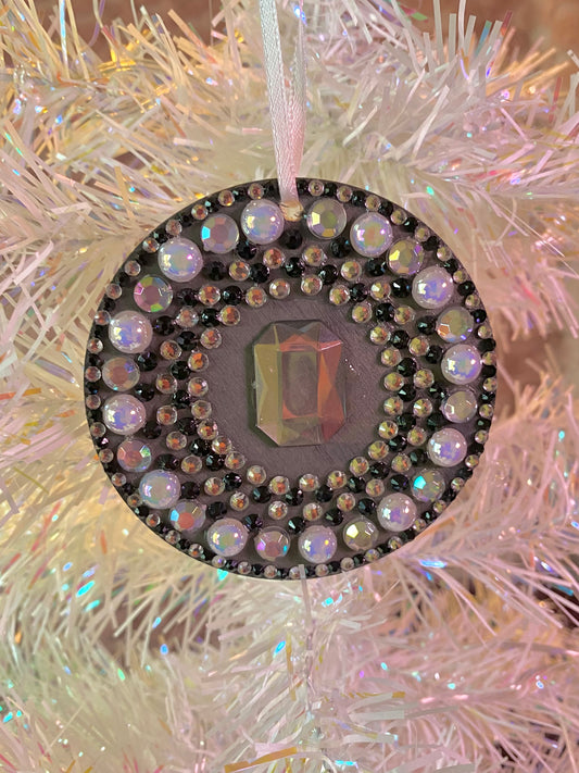 black round ornament with black and white gems