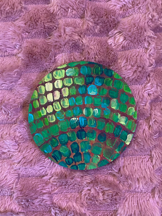 round disco ball magnet in shades of green and yellow