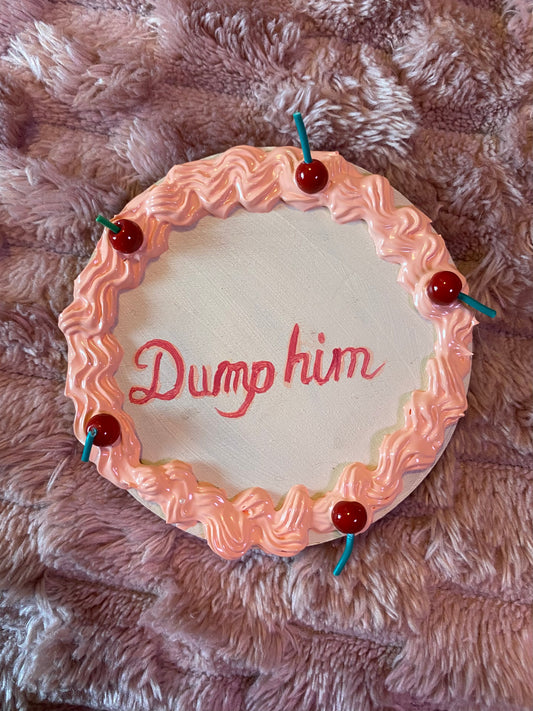 magnet made to look like a cake with "dump him" written as the message